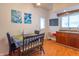 Eat-in kitchen features a cozy dining table, an adjacent window, and hardwood floors at 1633 E Thompson Rd, Indianapolis, IN 46227