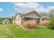 Charming home featuring tan siding, brick accents, a covered front porch, and well-maintained landscaping at 1633 E Thompson Rd, Indianapolis, IN 46227
