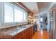 Well-lit kitchen with stainless steel appliances, wood cabinets, and double basin sink at 1633 E Thompson Rd, Indianapolis, IN 46227