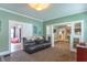 Open-concept living room with comfortable seating, soft carpeting, and a view into other rooms at 1633 E Thompson Rd, Indianapolis, IN 46227