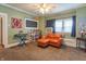 Cozy living room features a comfortable leather chair, a decorative blackboard, and plenty of natural light at 1633 E Thompson Rd, Indianapolis, IN 46227