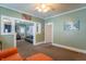 Bright living room with multiple seating areas, ceiling fan, and doorway to another room at 1633 E Thompson Rd, Indianapolis, IN 46227