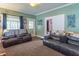 Comfortable living room showcasing cozy seating, soft carpeting, and an open doorway at 1633 E Thompson Rd, Indianapolis, IN 46227