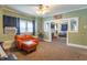 Comfortable living room with large windows, ceiling fan, and an open layout to additional living spaces at 1633 E Thompson Rd, Indianapolis, IN 46227