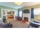 Spacious living room with a decorative fireplace, comfortable seating, and an open layout to another room at 1633 E Thompson Rd, Indianapolis, IN 46227