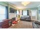 Inviting living room featuring a white brick fireplace, large windows, and comfortable seating at 1633 E Thompson Rd, Indianapolis, IN 46227