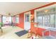 Cozy sunroom featuring ample light, casual seating, and an inviting rocking chair at 1633 E Thompson Rd, Indianapolis, IN 46227