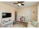 Bedroom area includes a TV on wall, alphabet rug, and kitchen playset at 177 Tracy Ridge Blvd, Whiteland, IN 46184