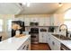 Modern kitchen with white cabinets, stainless steel appliances, and a central island with marble countertop at 177 Tracy Ridge Blvd, Whiteland, IN 46184