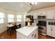 Bright kitchen features a breakfast nook, island with marble countertop, and stainless steel appliances at 177 Tracy Ridge Blvd, Whiteland, IN 46184