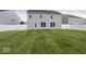 Large backyard featuring a well-maintained lawn and a white vinyl fence that offers both privacy and aesthetic appeal at 2006 Creek Bank Dr, Columbus, IN 47201