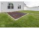 Backyard area with well-kept lawn and a patio at 2006 Creek Bank Dr, Columbus, IN 47201
