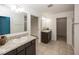 Bathroom features dual sinks with granite countertops, tile flooring, and neutral paint at 2006 Creek Bank Dr, Columbus, IN 47201
