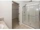Bright bathroom featuring a glass shower and walk-in closet at 2006 Creek Bank Dr, Columbus, IN 47201