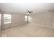 Bright bedroom with neutral walls, carpet, and ceiling fan plus two windows for natural light at 2006 Creek Bank Dr, Columbus, IN 47201