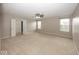 Large, neutral bedroom with ceiling fan, two windows, and closet with sliding doors at 2006 Creek Bank Dr, Columbus, IN 47201
