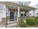 Inviting front porch with brick accents and charming lighting fixtures at 2006 Creek Bank Dr, Columbus, IN 47201