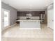 Eat-in kitchen features gray island, stainless appliances, tile backsplash and plenty of cabinet space at 2006 Creek Bank Dr, Columbus, IN 47201
