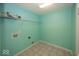 Laundry room with blue walls and tile floors at 2006 Creek Bank Dr, Columbus, IN 47201