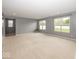 Spacious living room with ample natural light and neutral carpet at 2006 Creek Bank Dr, Columbus, IN 47201