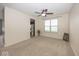 Bright living room with neutral carpet, a ceiling fan, and a view into the kitchen at 2006 Creek Bank Dr, Columbus, IN 47201