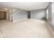 Open-concept living area with neutral paint, carpet, and easy access to the staircase at 2006 Creek Bank Dr, Columbus, IN 47201