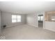 Bright living room featuring neutral carpet, gray walls, and natural light from large windows at 2006 Creek Bank Dr, Columbus, IN 47201
