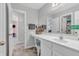 Bright bathroom featuring a vanity with a large mirror, chair, and a doorway at 2261 Shadow Trace Way, Greenwood, IN 46143
