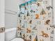 A cozy bathroom featuring a whimsical woodland-themed shower curtain with friendly animal designs at 2261 Shadow Trace Way, Greenwood, IN 46143