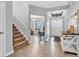 Inviting foyer featuring wood floors, staircase, chandelier and entry to the living area and a front door at 2261 Shadow Trace Way, Greenwood, IN 46143