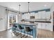 Well-lit kitchen featuring an island with seating, stainless steel appliances, and a sliding glass door to the outside at 2261 Shadow Trace Way, Greenwood, IN 46143