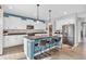 Modern kitchen with white cabinetry, an island with bar seating, stainless steel appliances, and stylish pendant lighting at 2261 Shadow Trace Way, Greenwood, IN 46143