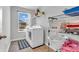 Bright laundry room featuring modern appliances, shelving, and a window for natural light at 2261 Shadow Trace Way, Greenwood, IN 46143