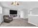 Cozy living room with a mounted TV and a comfortable leather recliner on neutral carpet at 2261 Shadow Trace Way, Greenwood, IN 46143