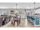 Open-concept living space featuring the dining area, kitchen bar seating, and a glimpse of the living area at 2261 Shadow Trace Way, Greenwood, IN 46143