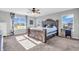 Comfortable bedroom features a large bed, a ceiling fan, and natural light from two windows overlooking the neighborhood at 2261 Shadow Trace Way, Greenwood, IN 46143