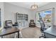 Bright and airy office space with a large window, comfortable seating, and a stylish display cabinet at 2261 Shadow Trace Way, Greenwood, IN 46143
