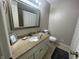 Clean bathroom featuring a tiled countertop, a rug, and a large mirror at 247 N 150 W, Greenfield, IN 46140