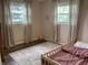 bedroom with wood floors, neutral walls, natural light, and toddler bed at 247 N 150 W, Greenfield, IN 46140