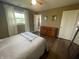 Bright bedroom features wood-look floors, neutral decor, and ample natural light at 247 N 150 W, Greenfield, IN 46140