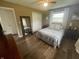 Comfortable bedroom with a large mirror, wooden floors, and plenty of natural light at 247 N 150 W, Greenfield, IN 46140