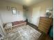 Comfortable bedroom with wooden floors, dresser, and toddler bed at 247 N 150 W, Greenfield, IN 46140
