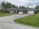 Wide view of the home showing a long driveway leading to the attached garage at 247 N 150 W, Greenfield, IN 46140