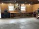 Spacious garage featuring a work bench, peg board for tools, and concrete flooring at 247 N 150 W, Greenfield, IN 46140