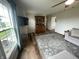 Open living room featuring a classic china cabinet, large window, and comfortable seating area at 247 N 150 W, Greenfield, IN 46140
