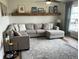 Comfortable living room with a plush sectional sofa, decorative shelf, and large area rug at 247 N 150 W, Greenfield, IN 46140