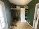 Mudroom with built-in bench, coat hooks, and storage shelves, plus a view to the side yard at 247 N 150 W, Greenfield, IN 46140