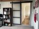 Bright office space featuring a barn door and a neatly organized bookshelf at 247 N 150 W, Greenfield, IN 46140