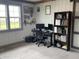 Functional office space with modern desk, chair, shelving, and large window at 247 N 150 W, Greenfield, IN 46140