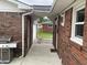 Outdoor walkway connecting the house with a covered area, featuring brick and grill at 247 N 150 W, Greenfield, IN 46140